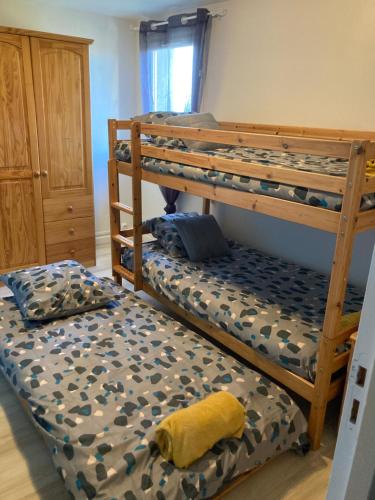 a bedroom with two bunk beds and a yellow pillow at Gîte à la ferme: Coig de Lamothe in Aramits