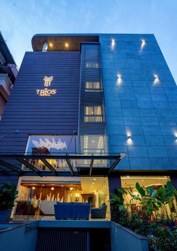 a tall blue building with a tesla sign on it at The Trios Hotel in Cochin