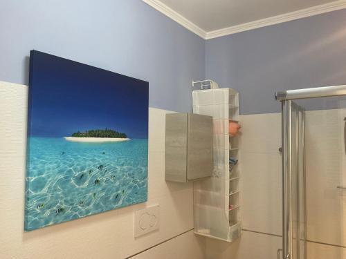 a painting of an island in the water in a bathroom at SEAFRONT in Portoferraio
