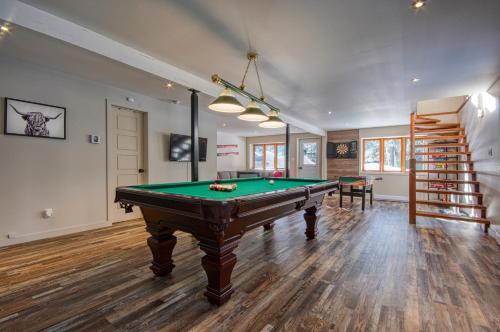 a room with a pool table and a staircase at Chalet familial, très bien situé in Mont-Blanc