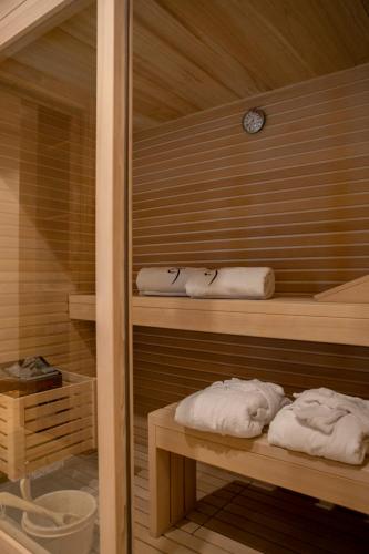 a sauna with two towels and a clock at Al Capriolo in Vodo Cadore