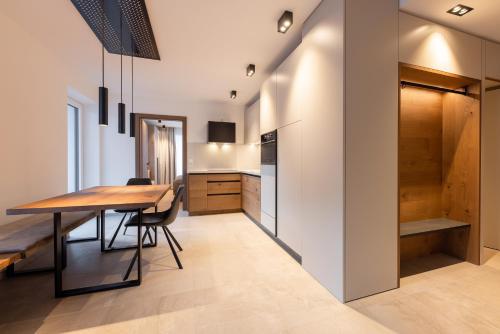 a kitchen and dining room with a table and chairs at Max Mountain Apartments in Neustift im Stubaital