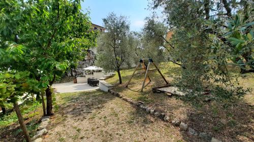 a garden with a swing in the middle of trees at Casa Elisabetta ShortLets in Caposele