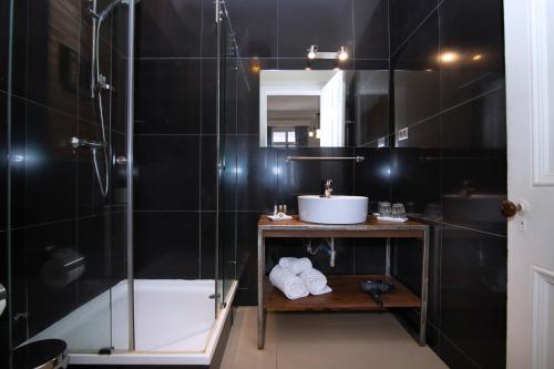 y baño con ducha y lavamanos. en New Voga Guesthouse, en Valparaíso