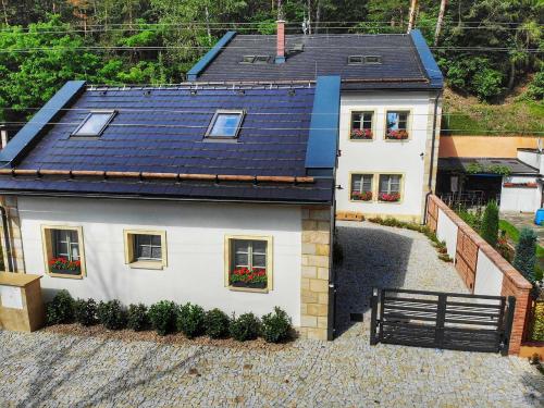 an aerial view of a white house with a black roof at Penzion Stodola in Weisswasser in Böhmen
