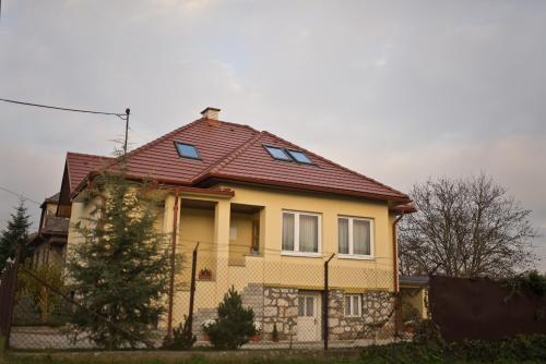 a yellow house with a red roof at Slovakia; space, tranquility and plenty of opportunities! Be welcome in Strawberry House! in Brzotín