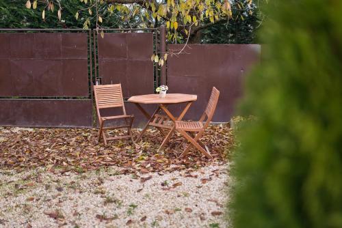 a table and two chairs sitting in a backyard at Slovakia; space, tranquility and plenty of opportunities! Be welcome in Strawberry House! in Brzotín