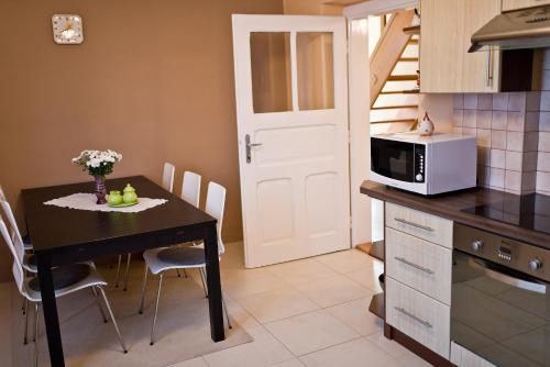 a small kitchen with a table and a microwave at Slovakia; space, tranquility and plenty of opportunities! Be welcome in Strawberry House! in Brzotín