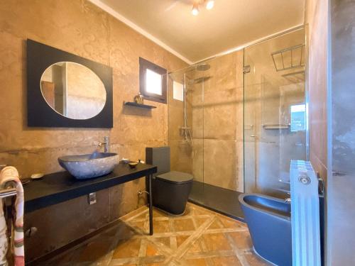 a bathroom with a sink and a glass shower at Holiday Home Rosa in L'Escala