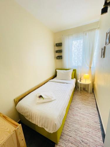 a small room with a bed and a window at Perfect Place to Stay self check in-24h-NETFLIX-WIFI in Reşiţa