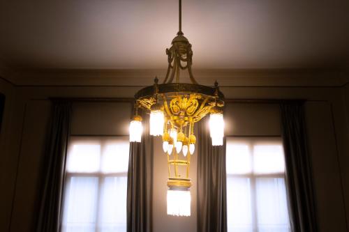 a chandelier hanging from a ceiling in front of a window at New Voga Hotel Boutique in Valparaíso