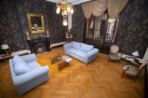 a living room with two couches and a fireplace at New Voga Hotel Boutique in Valparaíso
