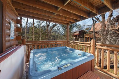 a hot tub on the deck of a cabin at Moose Tracks cabin in Pigeon Forge