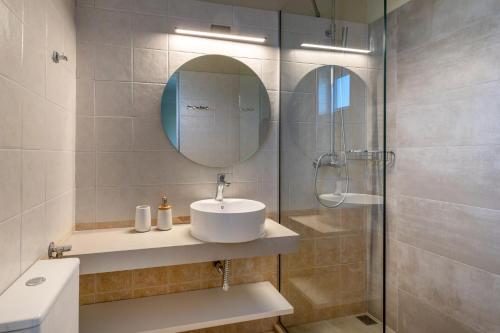 a bathroom with a sink and a shower at Fedra Plakias Apartments in Plakias