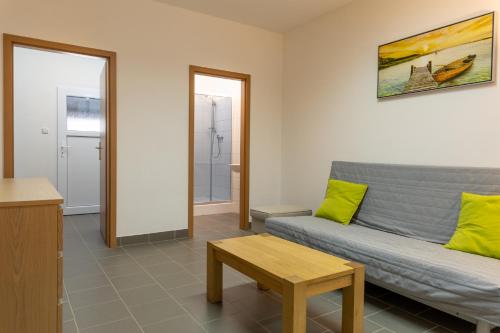 a living room with a couch and a table at Apartmány SKI KRASLICE - NOVĚ OTEVŘENO in Kraslice