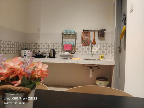 a small kitchen with a counter and a sink at PavilionVillie Ipoh in Kampong Sengat
