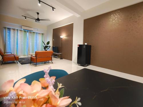 a living room with a couch and a tv in it at PavilionVillie Ipoh in Kampong Sengat