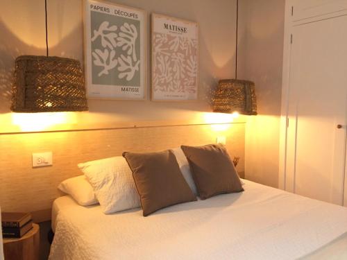 a bedroom with a white bed with two pillows at Joya en Orense Centro in Ourense