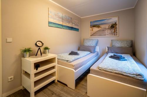 a bedroom with two beds and a night stand at Bördeapartment 2 in Vahldorf