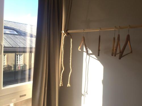 a room with a window with a curtain and hangers at Joya en Orense Centro in Ourense