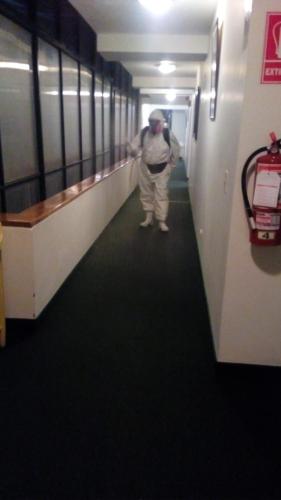 a man walking down a hallway in a building at Plaza Mayor Hotel in Puno