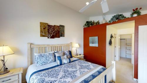 a bedroom with a bed with blue and white pillows at Arches Abode #A3 in Moab
