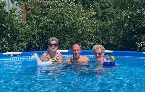 a man and a woman in a swimming pool at Combrailleurs Gite in Espinasse