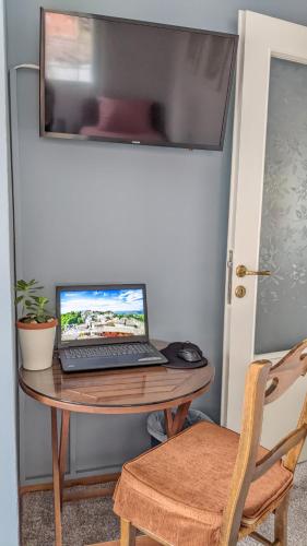 a laptop computer sitting on a wooden table at Sapho's House in Leonidion
