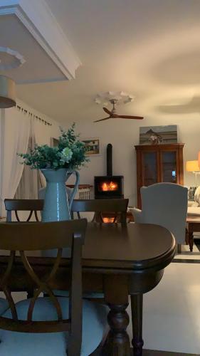 a living room with a table and a fireplace at La Quinta - La Barrosa in Chiclana de la Frontera