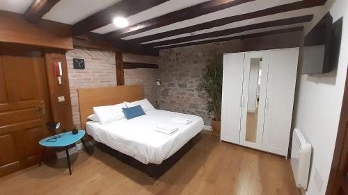 a bedroom with a bed and a table in it at LUXURY IN OLD TOWN NEAR BEACH by www,SanSebastianApartments,es in Donostia-San Sebastián