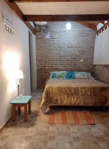a bedroom with a bed and a table with a lamp at TENDERETE in Villa General Belgrano