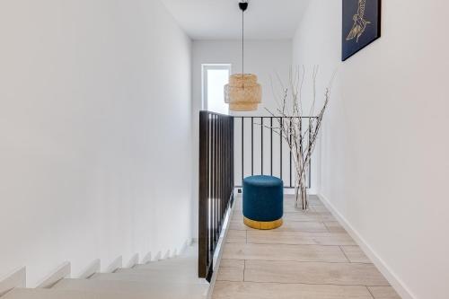 a hallway with a blue ottoman next to a staircase at Villa Artemis in Plitvička Jezera