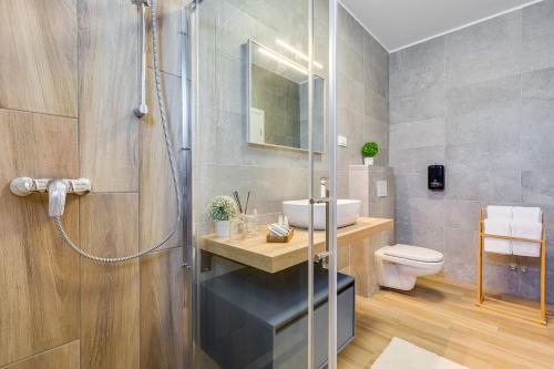 a bathroom with a shower and a sink and a toilet at Villa Artemis in Plitvička Jezera