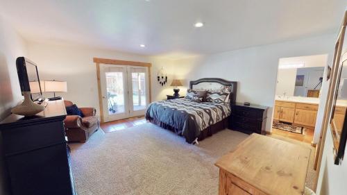 a bedroom with a bed and a dresser and a sink at Arena Roja #2279 in Moab