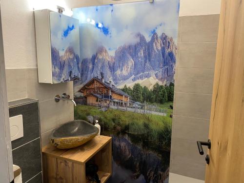 a bathroom with a sink and a mountain shower curtain at Berghof Haselsberger in Sankt Johann in Tirol