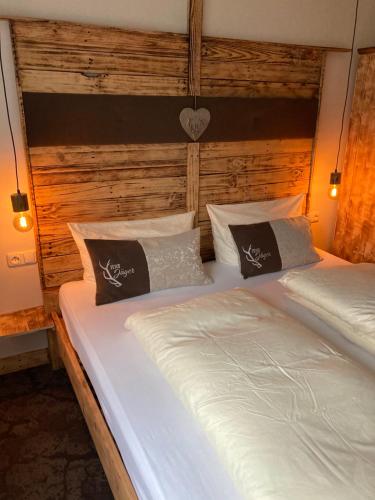 two twin beds in a room with wooden walls at FEWO Jäger in Willingen