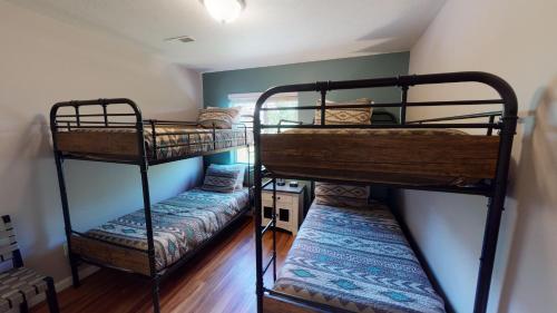 two bunk beds are in a room with a wall at Adventure Base Camp #381 in Moab