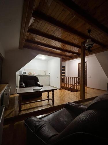 a living room with a couch and a table at Pensiunea Poiana Luminoasă in Bughea de Jos