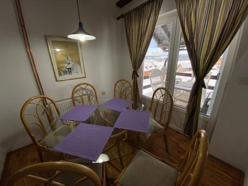 a dining room with a table and chairs and a window at Vila Jela Tornik in Zlatibor