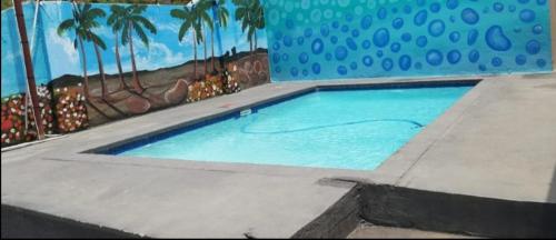 a swimming pool with a painting on the wall at BTV Guesthouse in Hazyview