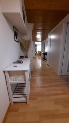 a room with a white table and a hallway at Large Apartment 8beds great for family and friends, Mountain View in Amden