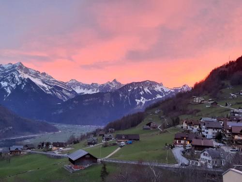 a village in a valley with snow covered mountains at Large Apartment 8beds great for family and friends, Mountain View in Amden