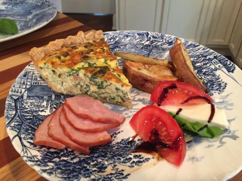 a blue and white plate of food on a table at Riverside Gables Bed and Breakfast in Berea
