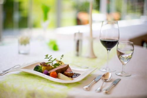 a plate of food and a glass of wine on a table at Family & Sporthotel Kärntnerhof in Bad Kleinkirchheim