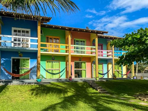 a colorful house with a palm tree in front of it at O Costão do Sol in Balneário Camboriú