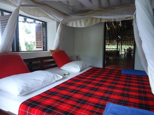 Кровать или кровати в номере Kusini Beach Cottages