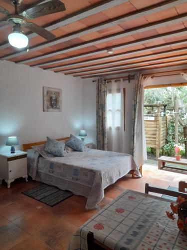 a bedroom with a bed and a large window at Complejo Sol de Valizas in Barra de Valizas