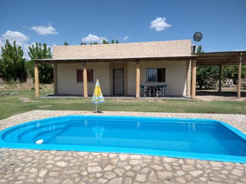 a pool in front of a house at Quinta Las Marías - Cabañas in San José de Jáchal