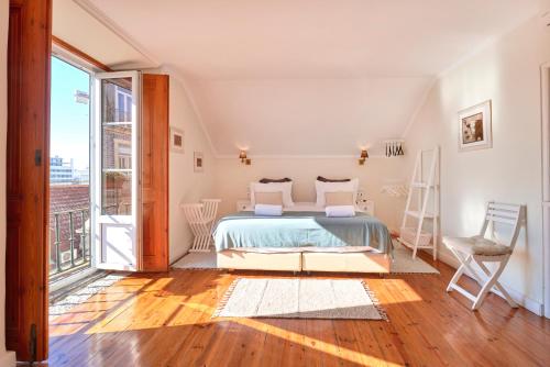 a room with a bed, chair and a window at Casa do Mercado Lisboa in Lisbon