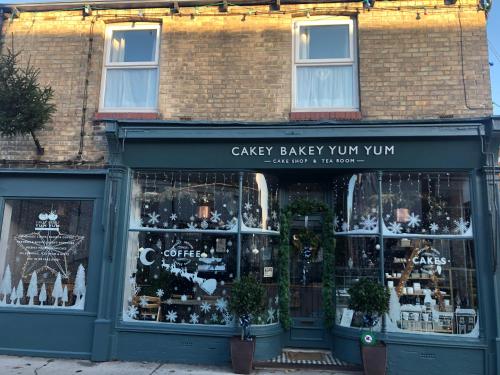 a store front of a bakery with christmas merchandise in the windows at Number One - Fully Equipped Self Catering Four Bedroom House next to Dunedin, 15 mins to Spurn, 20 mins to Saltend, 12 mins to Easington in Patrington